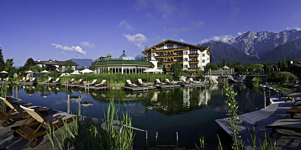 Premium spa resort with luxurious treatment tables, tranquil lake, and mountain views.