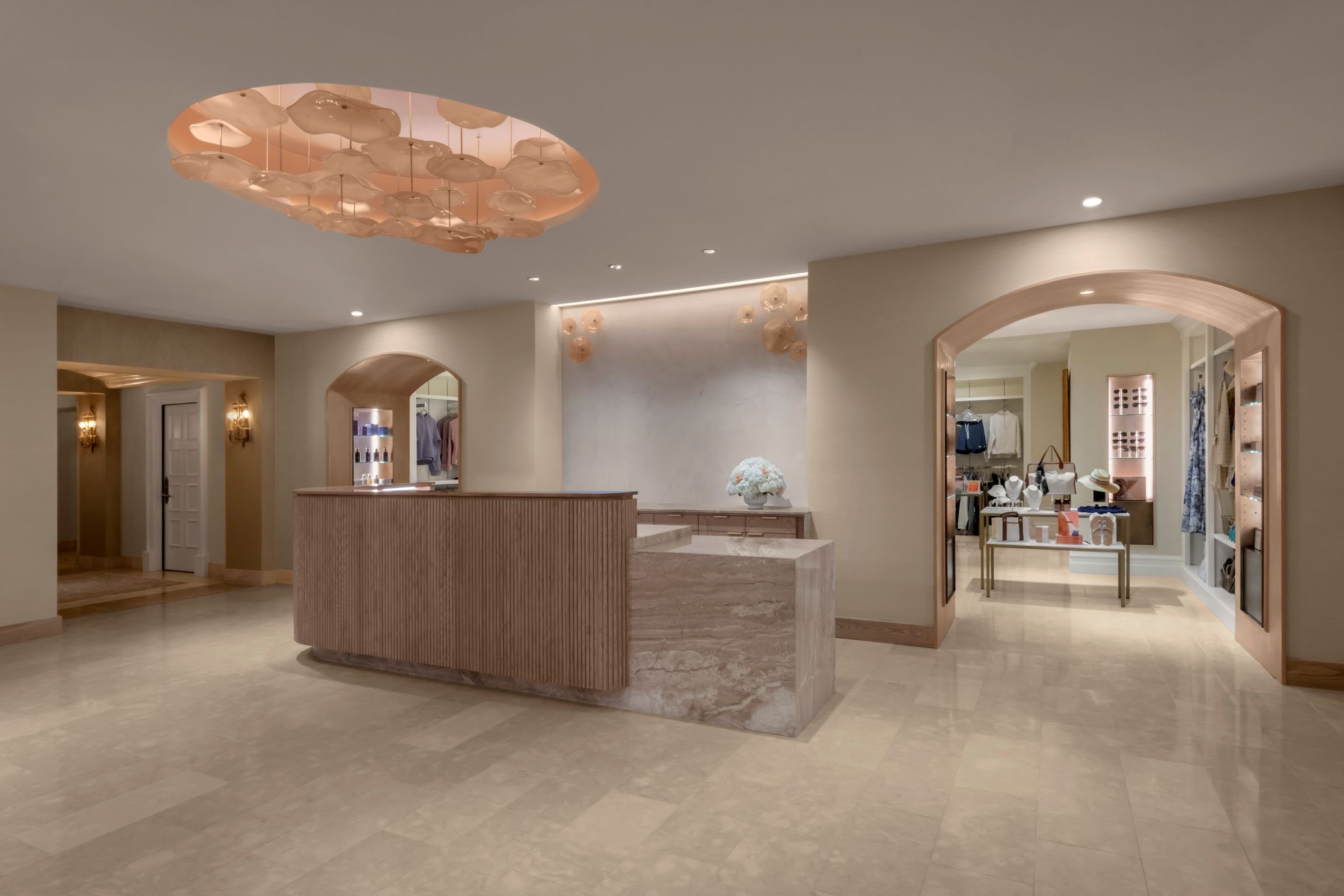 Luxurious spa reception with elegant marble desk and modern lighting at Gharieni.